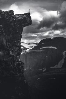 grayscale photo of rocky mountain under cloudy sky by Marek Piwnicki courtesy of Unsplash.